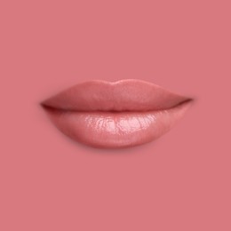 Image of Woman's lips against background matching color of her lipstick