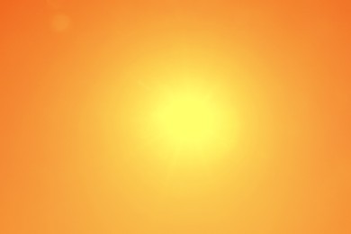 Image of Bright sun in orange sky during hot summer weather