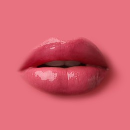 Image of Woman's lips against background matching color of her lipstick