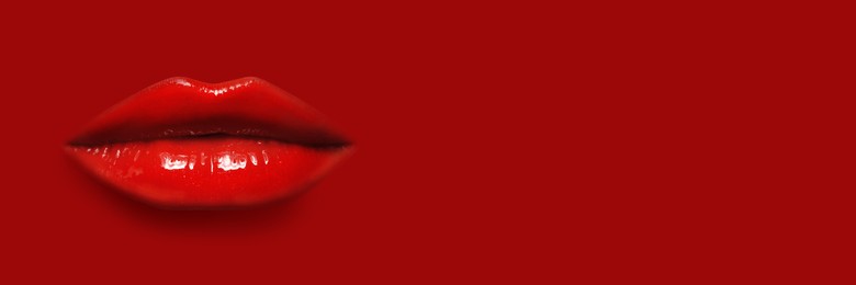 Image of Woman's lips against background matching color of her lipstick. Banner design with space for text