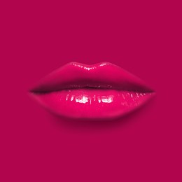 Image of Woman's lips against background matching color of her lipstick