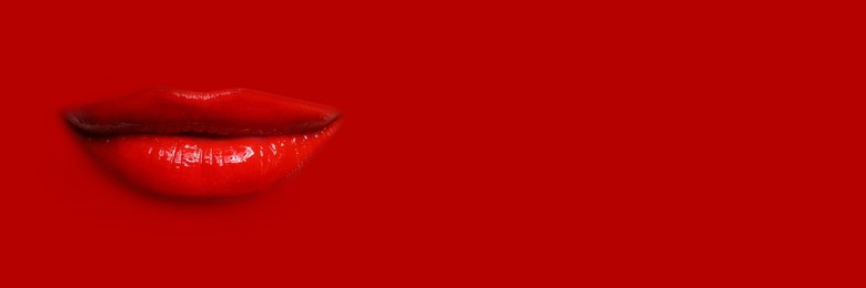Image of Woman's lips against background matching color of her lipstick. Banner design with space for text