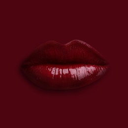 Image of Woman's lips against background matching color of her lipstick