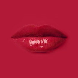 Image of Woman's lips against background matching color of her lipstick