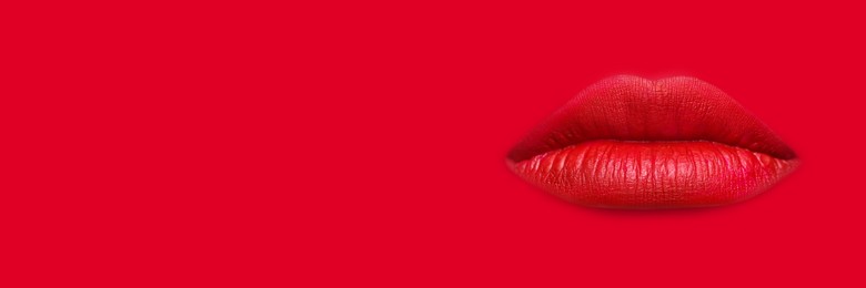 Image of Woman's lips against background matching color of her lipstick. Banner design with space for text