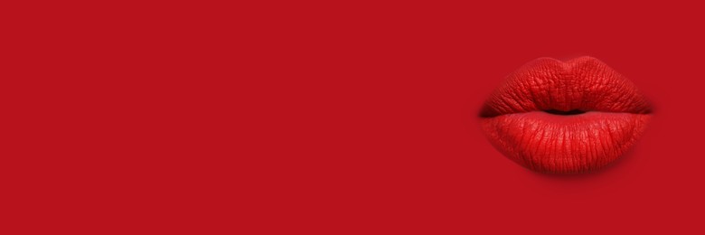 Image of Woman's lips against background matching color of her lipstick. Banner design with space for text