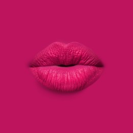 Image of Woman's lips against background matching color of her lipstick