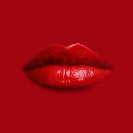 Image of Woman's lips against background matching color of her lipstick