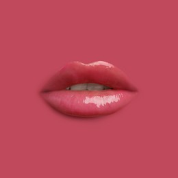 Image of Woman's lips against background matching color of her lipstick