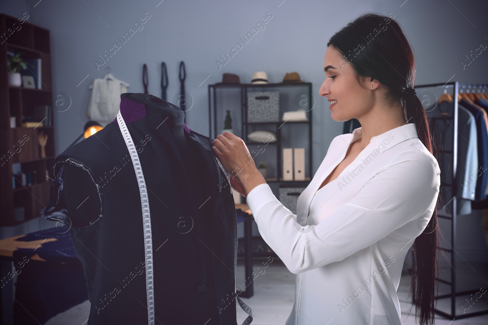 Image of Fashion designer working with mannequin in studio. Creating stylish clothes