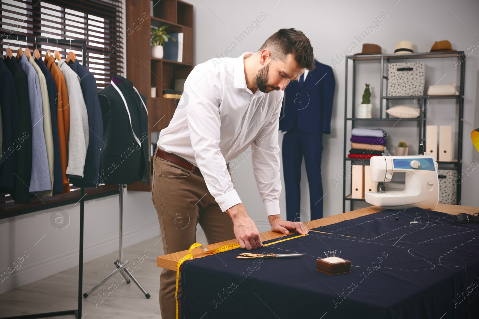 Image of Fashion designer working in studio. Creating stylish clothes