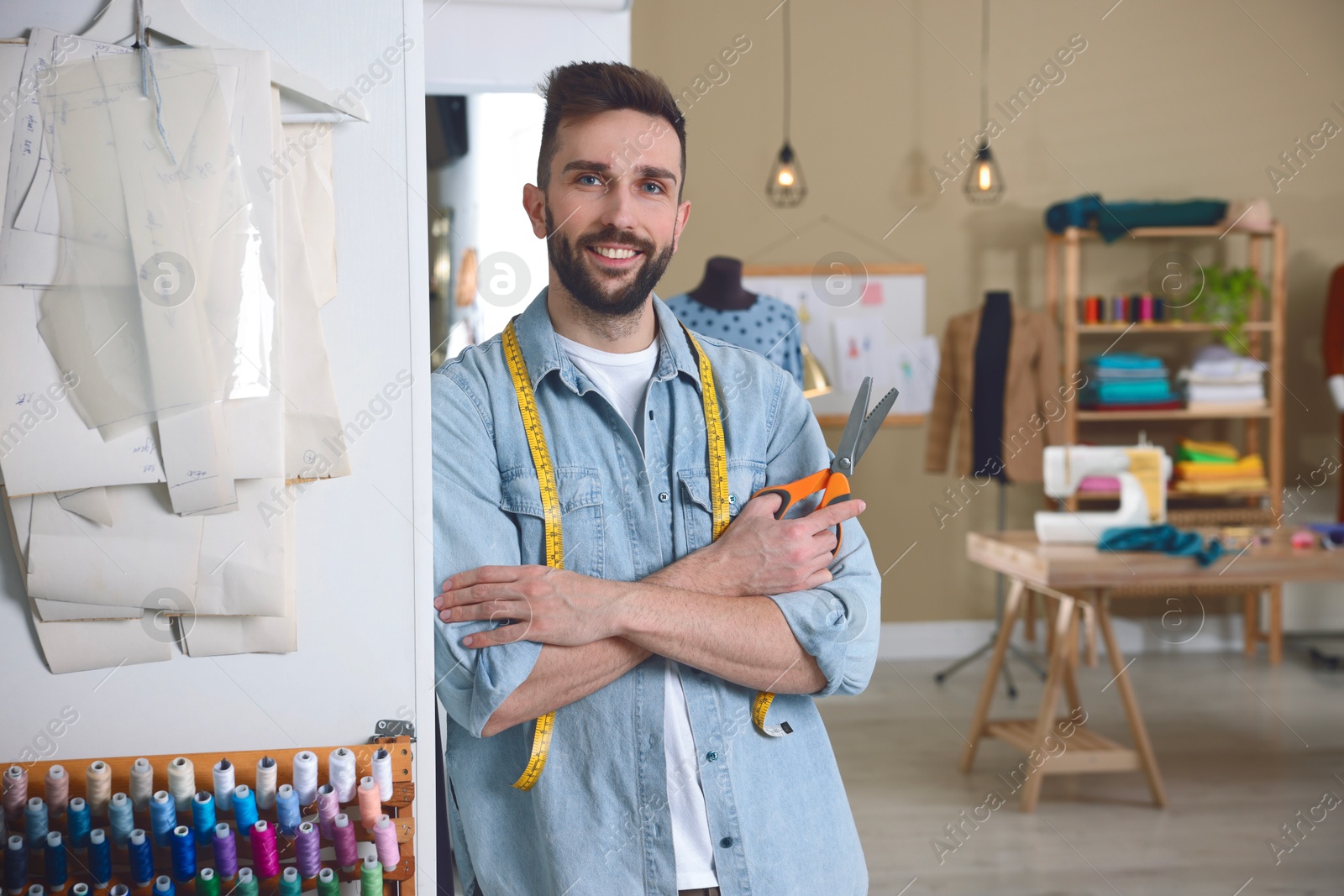 Image of Fashion designer in his studio. Creating stylish clothes