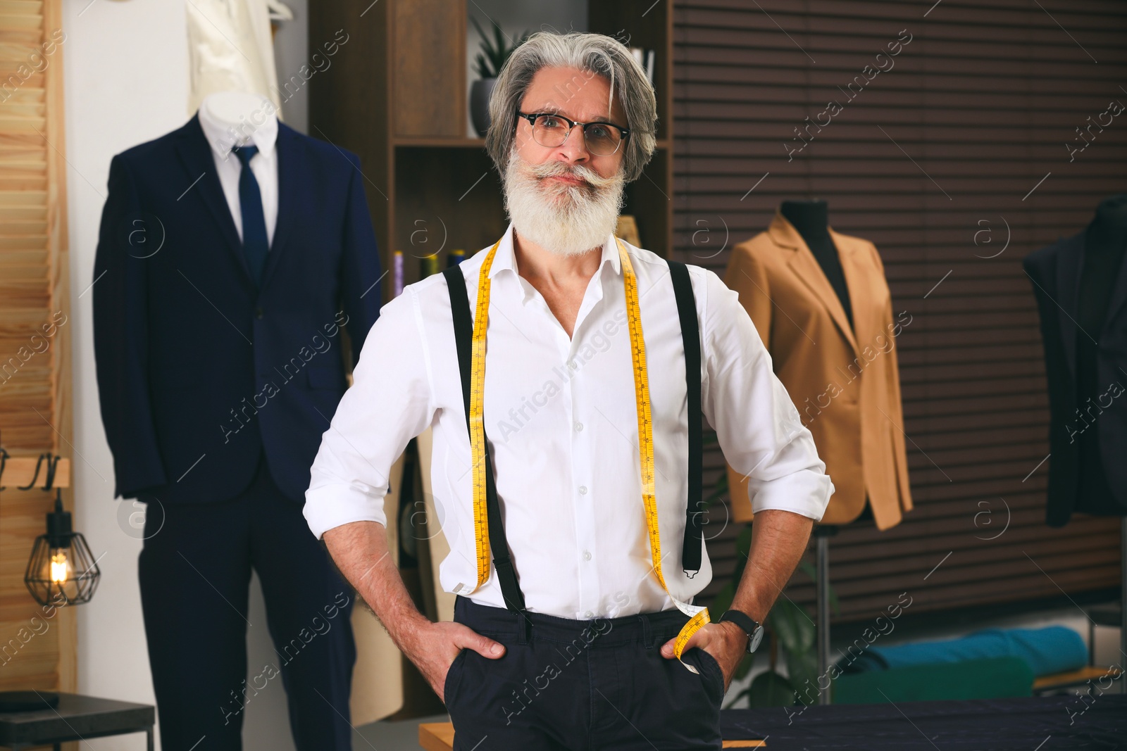 Image of Fashion designer in his studio. Creating stylish clothes