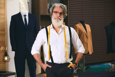 Image of Fashion designer in his studio. Creating stylish clothes