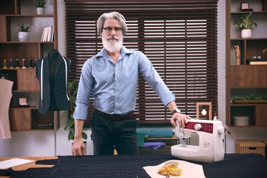 Image of Fashion designer in his studio. Creating stylish clothes