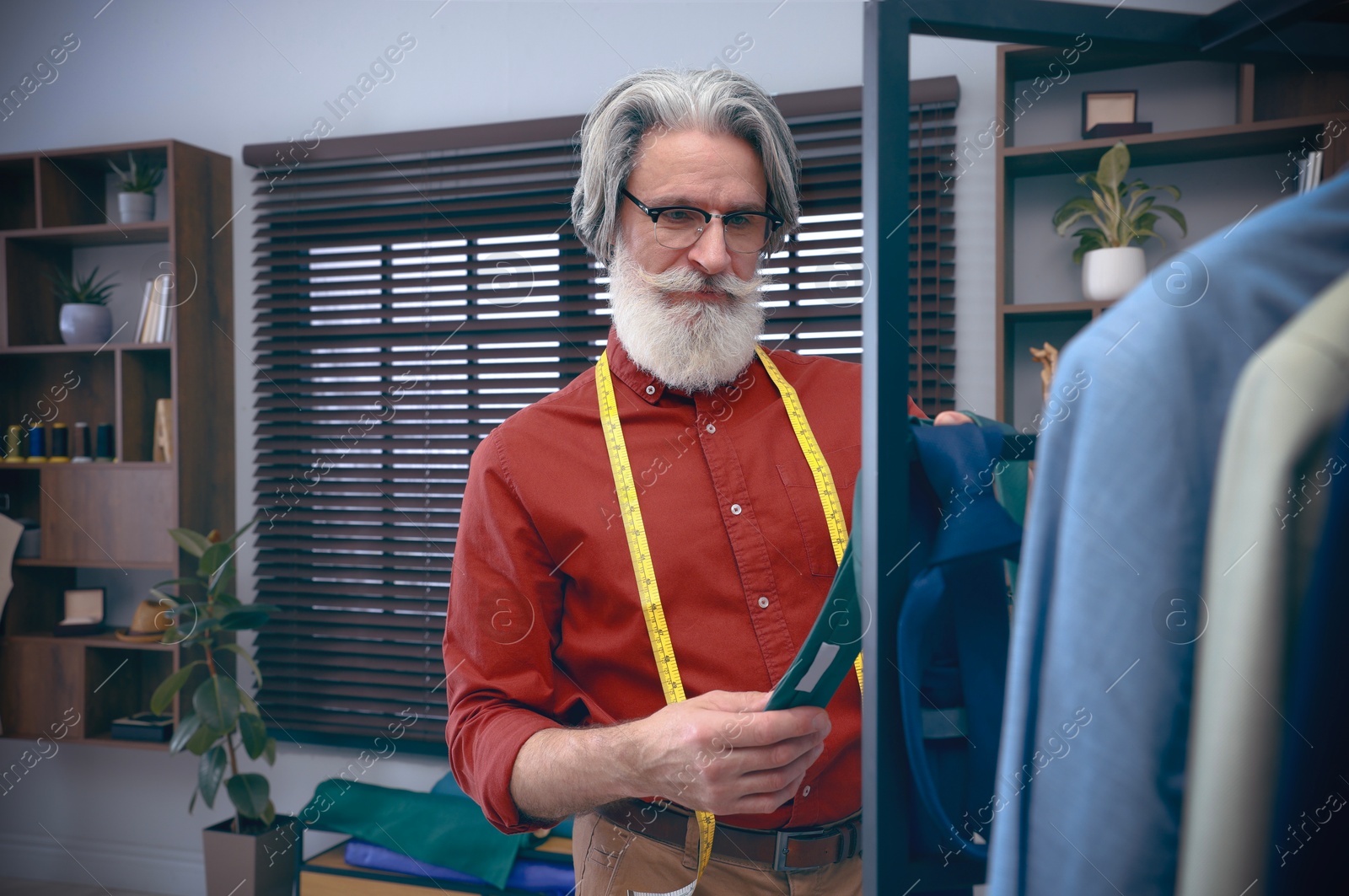 Image of Fashion designer working in studio. Creating stylish clothes