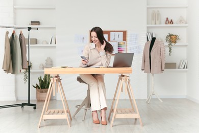 Image of Fashion designer working in studio. Creating stylish clothes