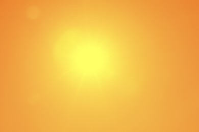 Image of Bright sun in orange sky during hot summer weather