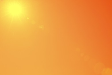 Image of Bright sun in orange sky during hot summer weather