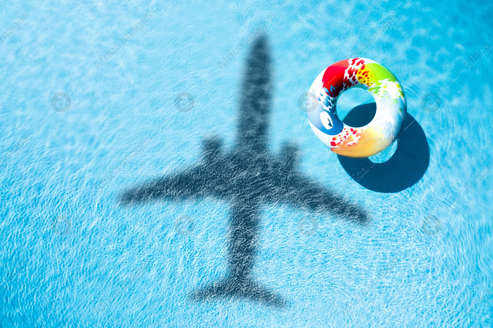 Inflatable ring floating in swimming pool, top view. Flying airplane casting shadow on water Image of Inflatable ring floating in swimming pool, top view. Flying airplane casting shadow on water