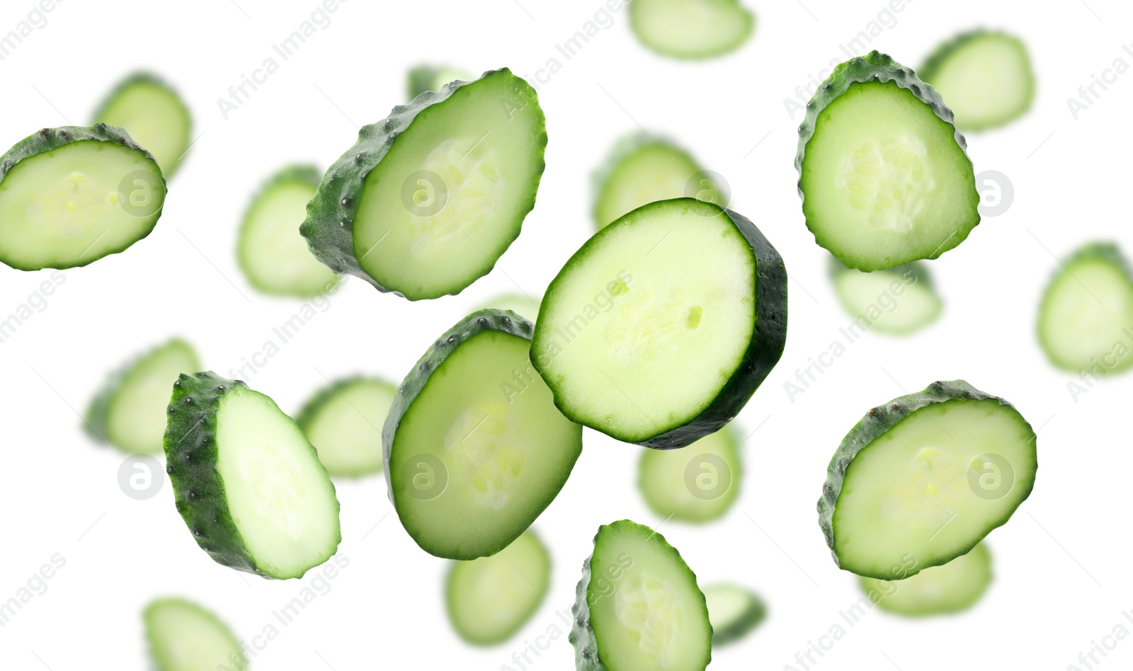 Pieces of fresh cucumbers falling on white background Image of Pieces of fresh cucumbers falling on white background
