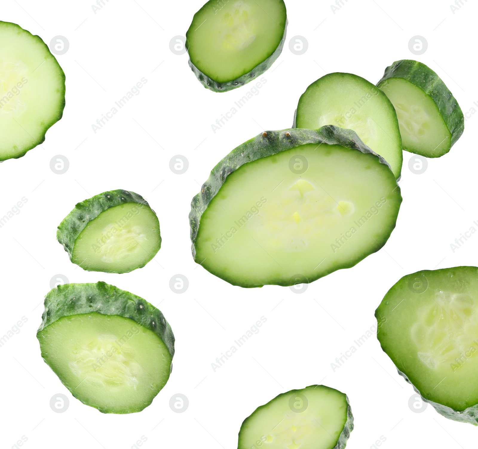 Pieces of fresh cucumbers falling on white background Image of Pieces of fresh cucumbers falling on white background