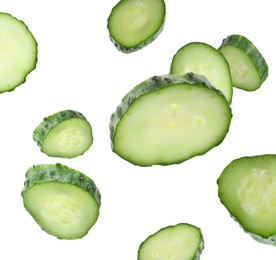 Image of Pieces of fresh cucumbers falling on white background