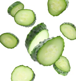 Image of Pieces of fresh cucumbers falling on white background