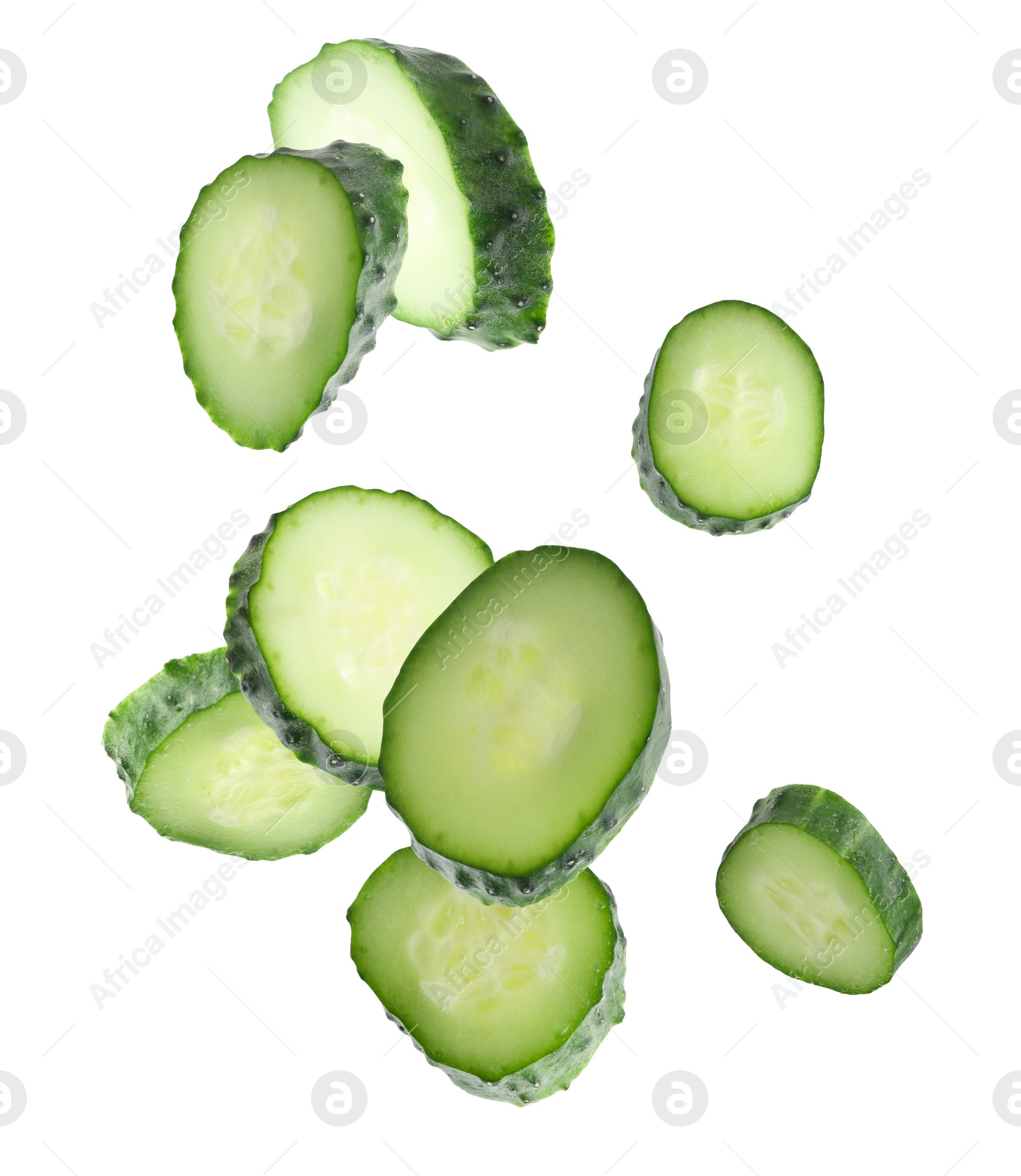 Pieces of fresh cucumbers falling on white background Image of Pieces of fresh cucumbers falling on white background