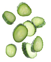 Image of Pieces of fresh cucumbers falling on white background