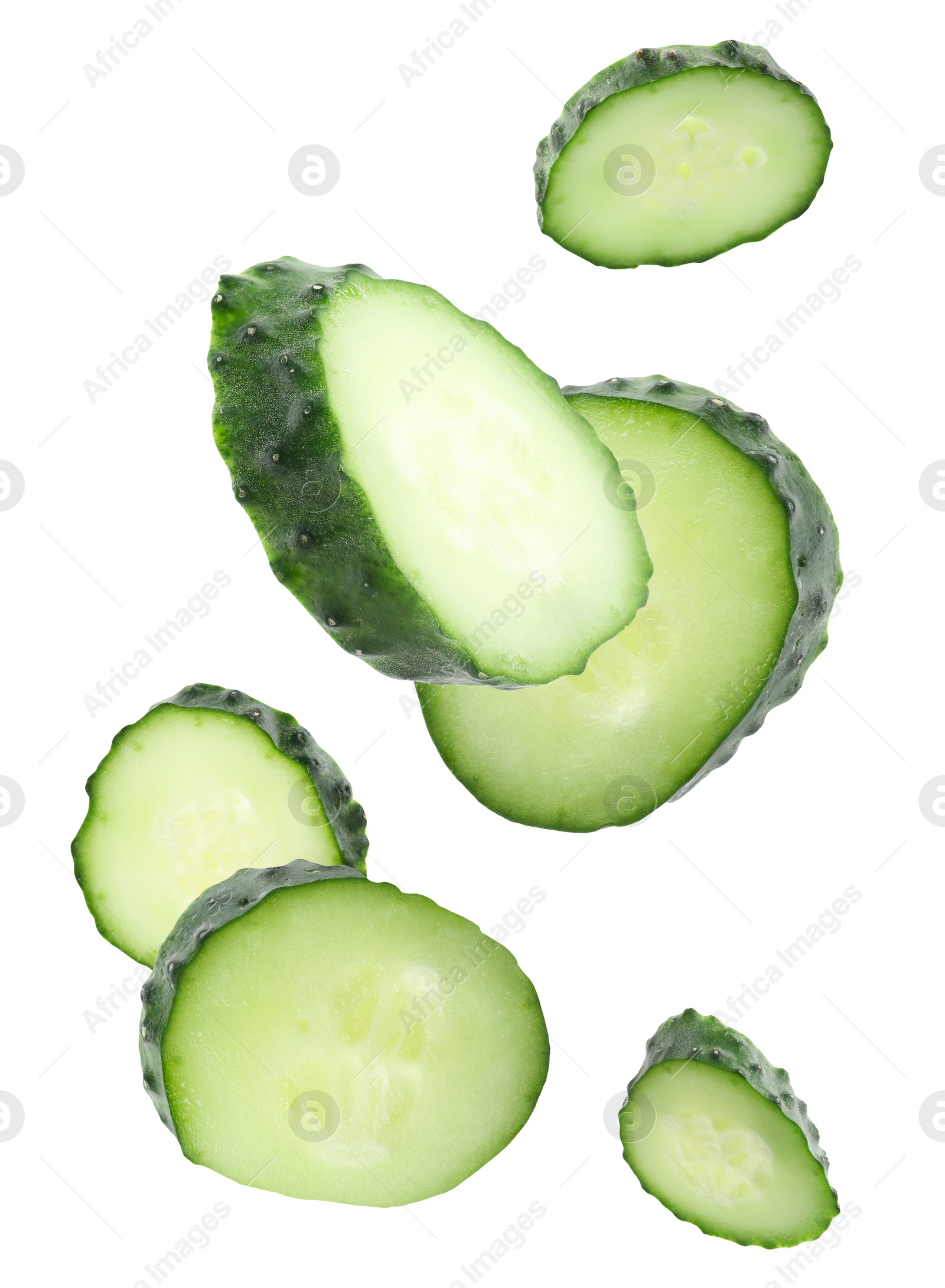 Pieces of fresh cucumbers falling on white background Image of Pieces of fresh cucumbers falling on white background
