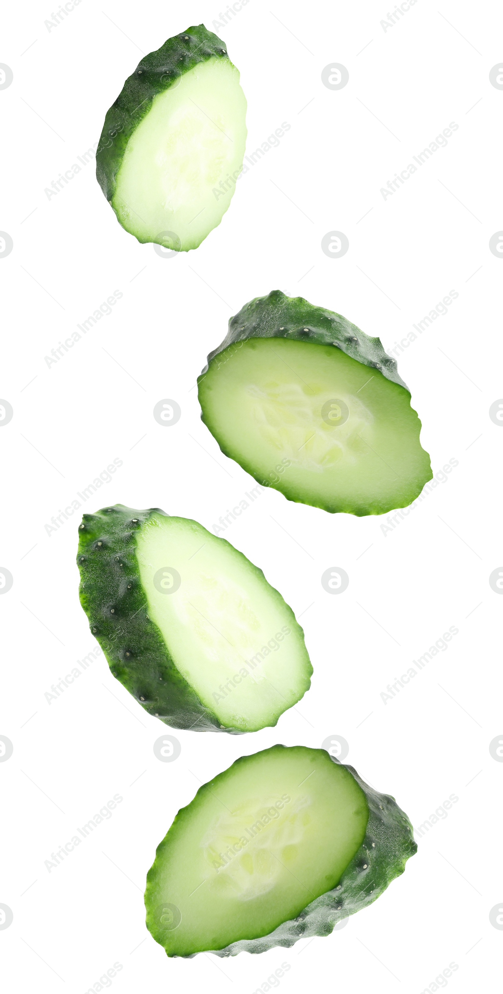 Pieces of fresh cucumbers falling on white background Image of Pieces of fresh cucumbers falling on white background