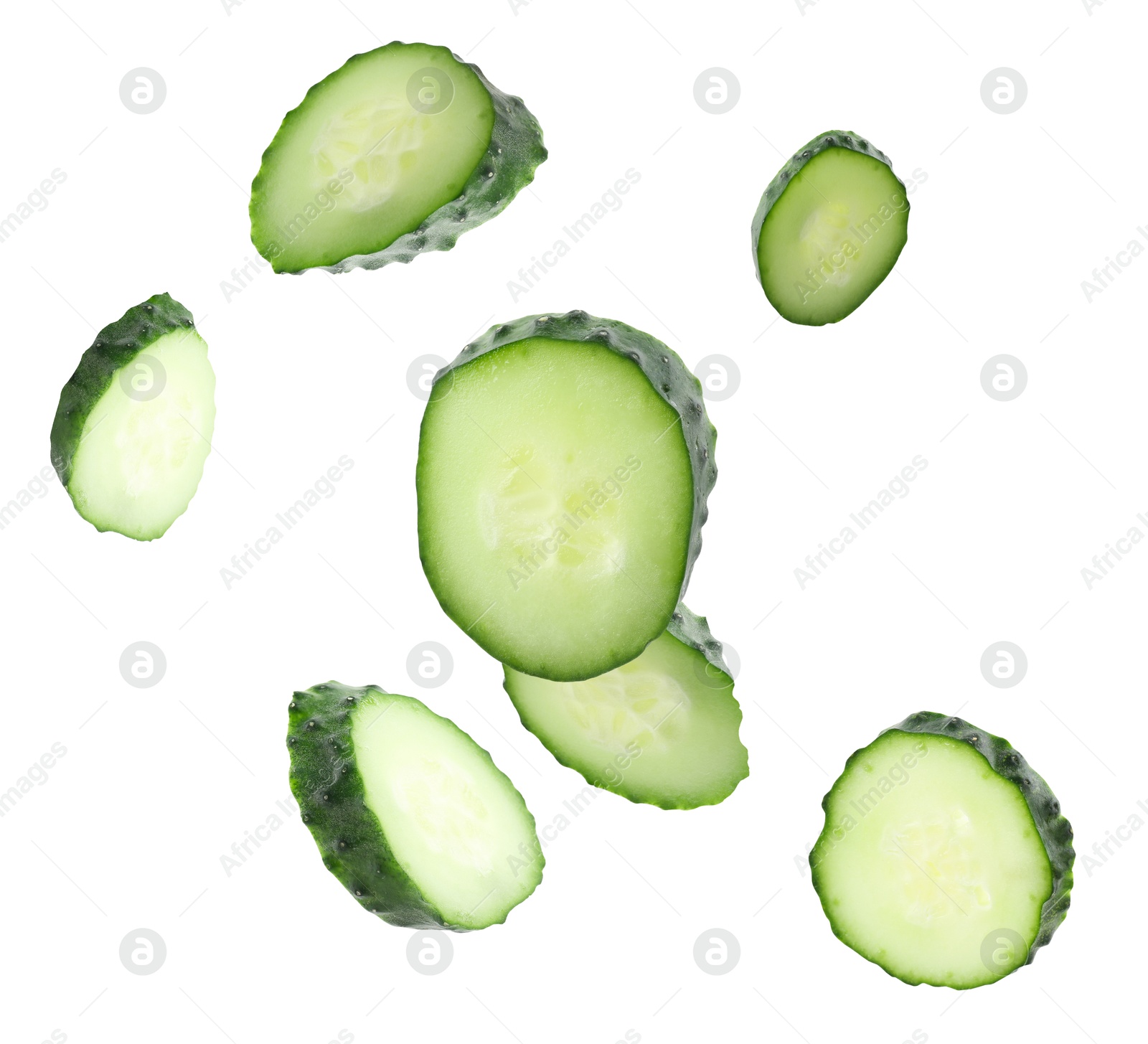 Pieces of fresh cucumbers falling on white background Image of Pieces of fresh cucumbers falling on white background