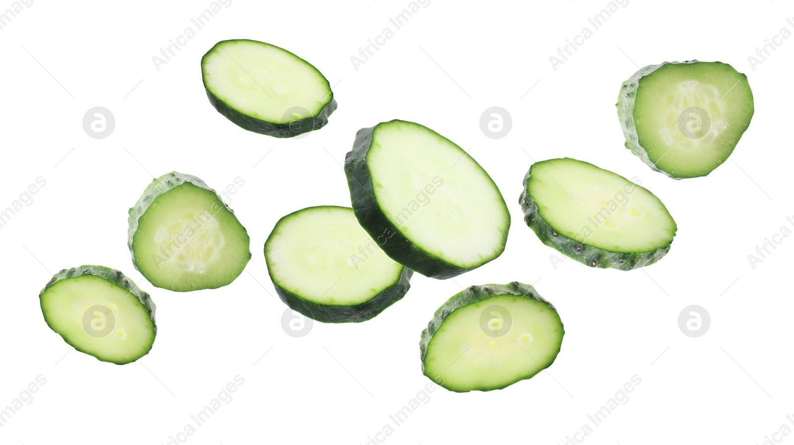 Pieces of fresh cucumbers falling on white background Image of Pieces of fresh cucumbers falling on white background