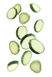 Image of Pieces of fresh cucumbers falling on white background