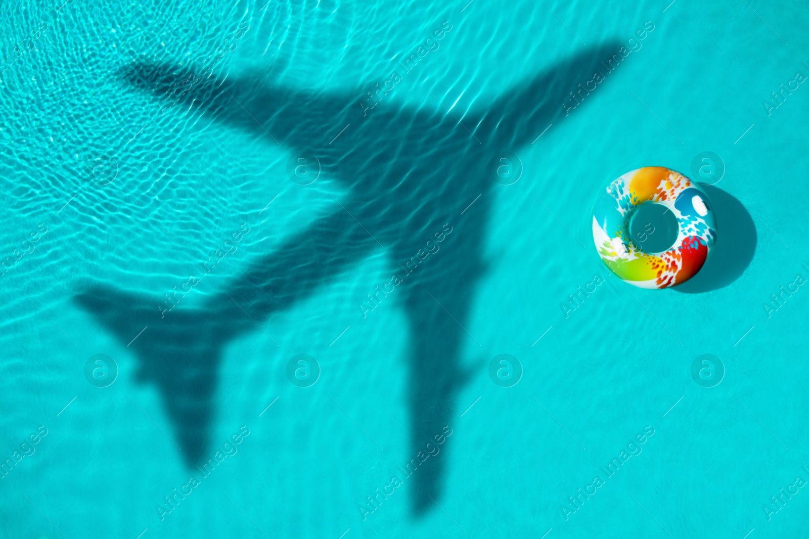 Inflatable ring floating in swimming pool, top view. Flying airplane casting shadow on water Image of Inflatable ring floating in swimming pool, top view. Flying airplane casting shadow on water