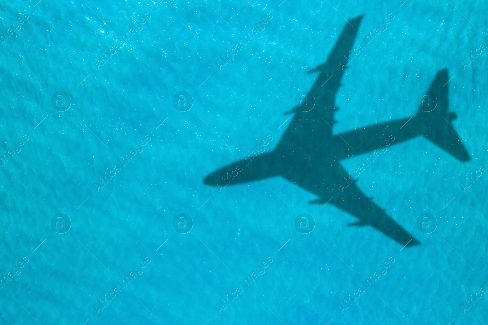 Flying airplane casting shadow on water, top view Image of Flying airplane casting shadow on water, top view