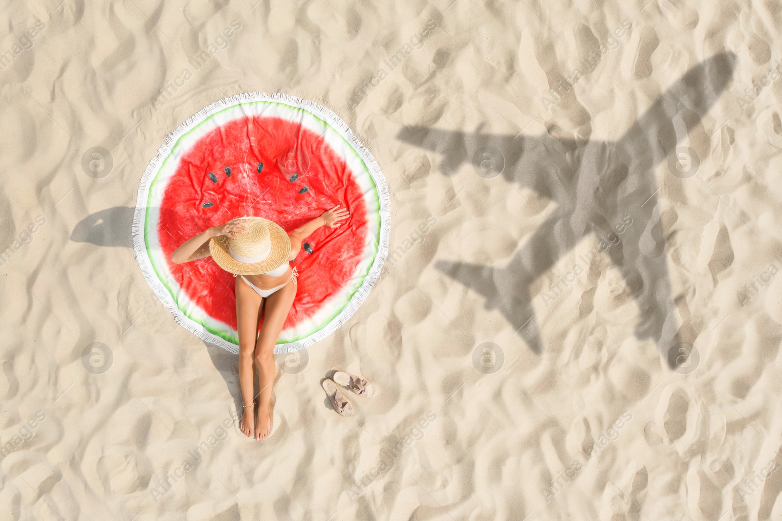 Woman sunbathing on beach, top view. Flying airplane casting shadow on sand Image of Woman sunbathing on beach, top view. Flying airplane casting shadow on sand