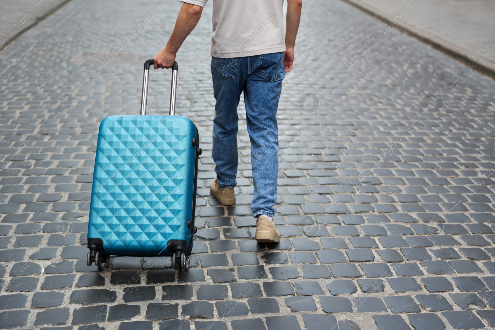 Goodbye. Man with luggage walking on city street, closeup. Space for text Photo of Goodbye. Man with luggage walking on city street, closeup. Space for text