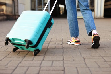 Photo of Goodbye. Woman with luggage on platform of railway station, closeup