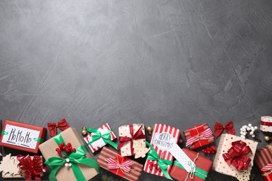 Photo of Flat lay composition with Christmas gift boxes on grey background. Space for text