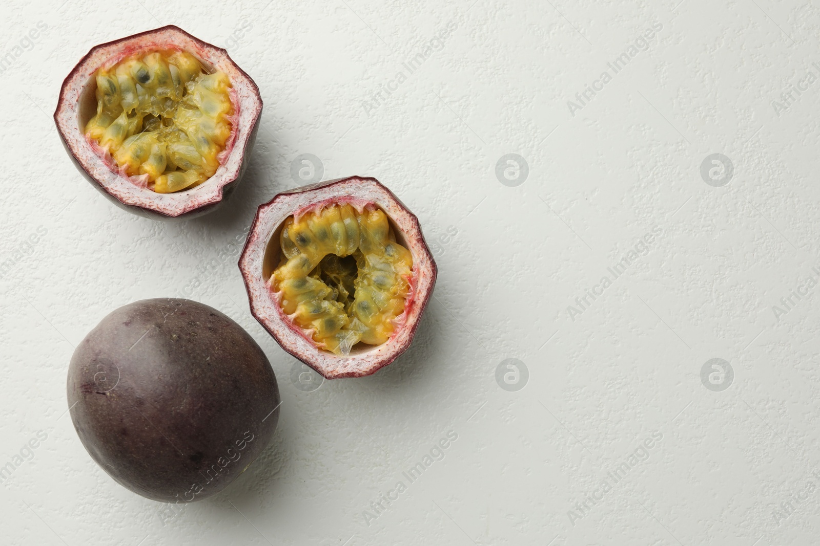 Fresh passion fruits on white table, flat lay. Space for text Photo of Fresh passion fruits on white table, flat lay. Space for text