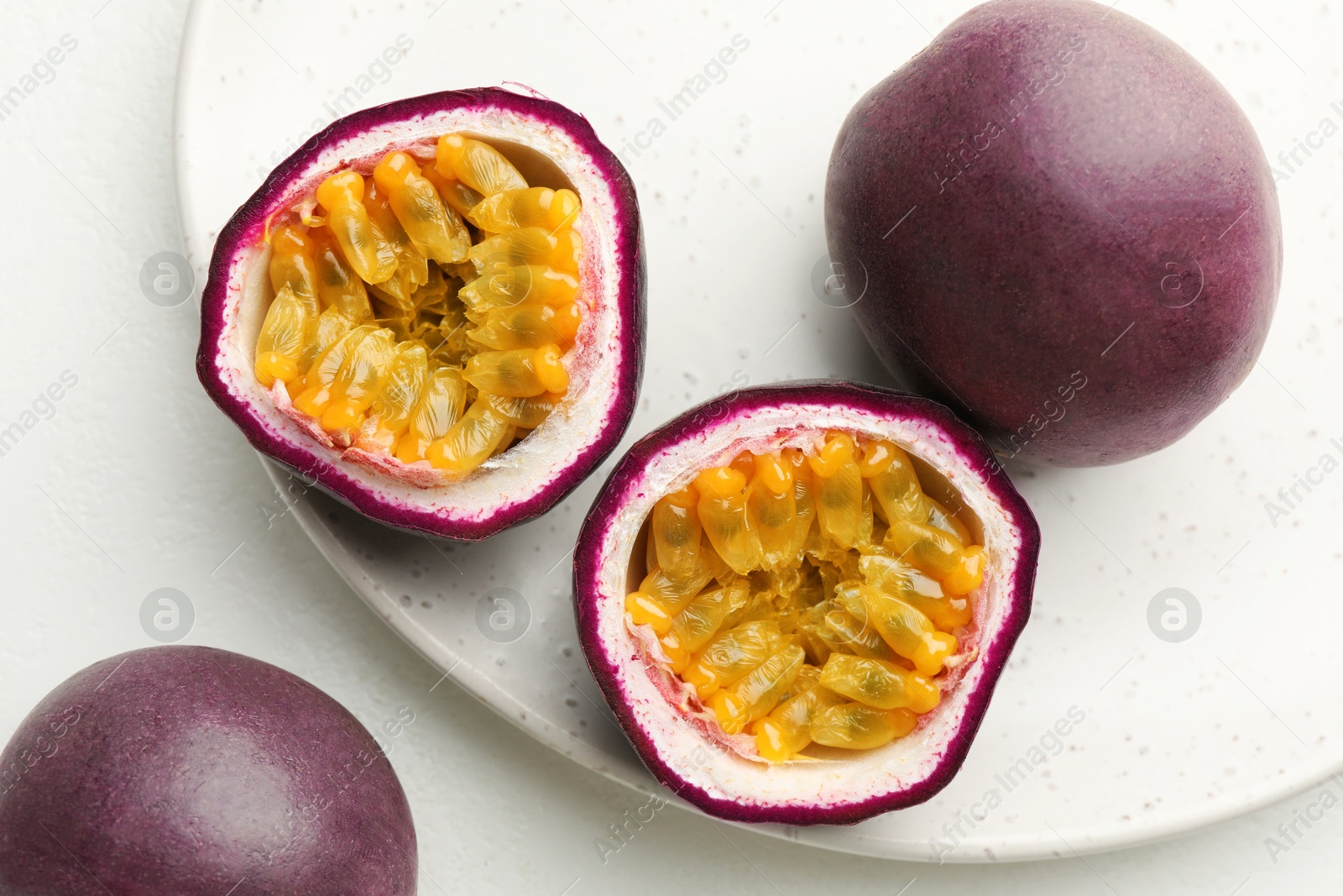 Fresh passion fruits on white table, closeup Photo of Fresh passion fruits on white table, closeup