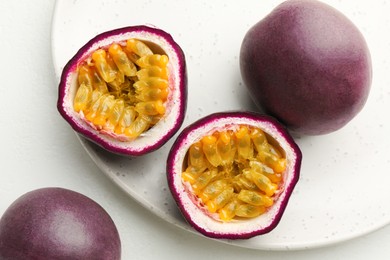 Photo of Fresh passion fruits on white table, closeup