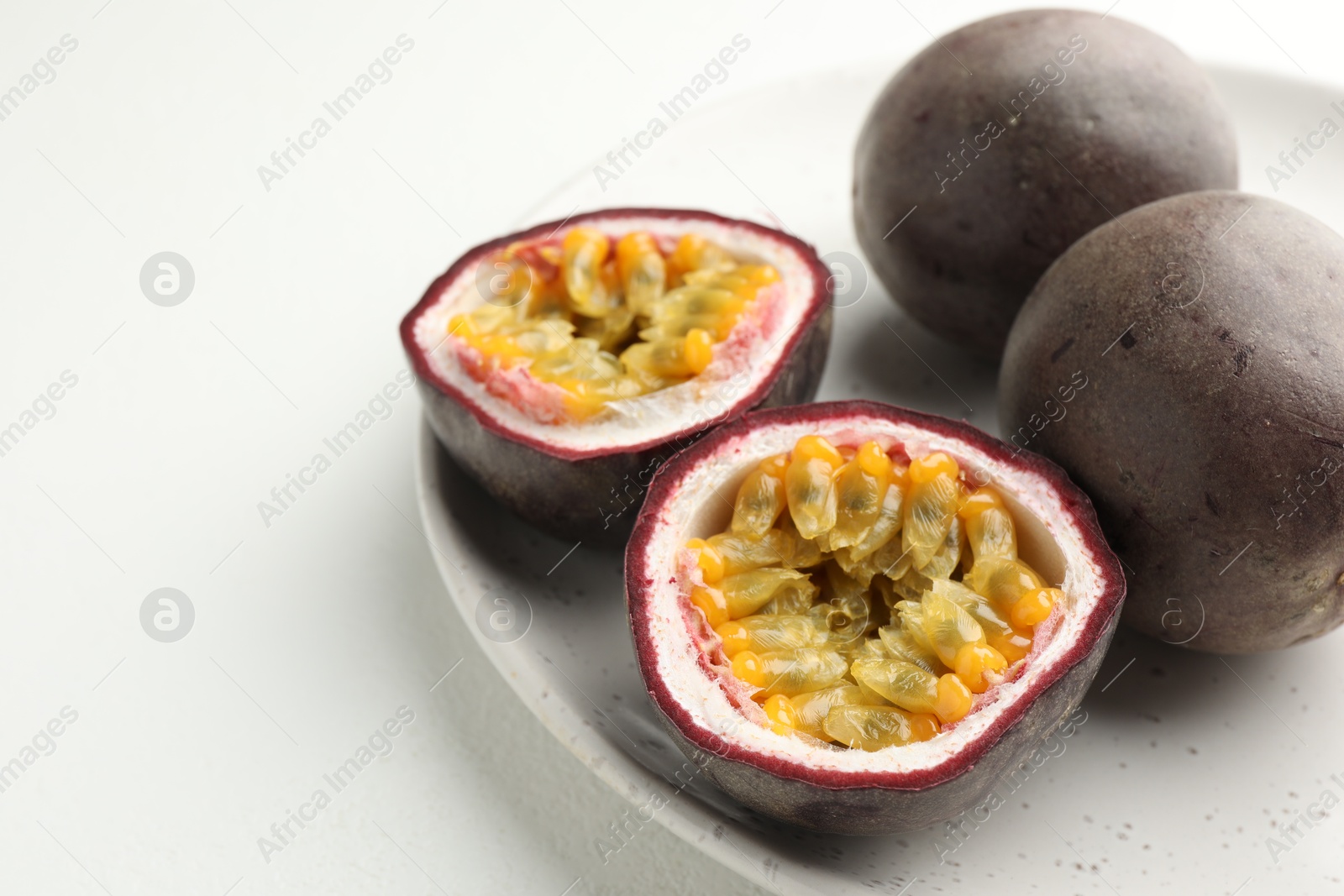 Fresh passion fruits on white table, closeup. Space for text Photo of Fresh passion fruits on white table, closeup. Space for text