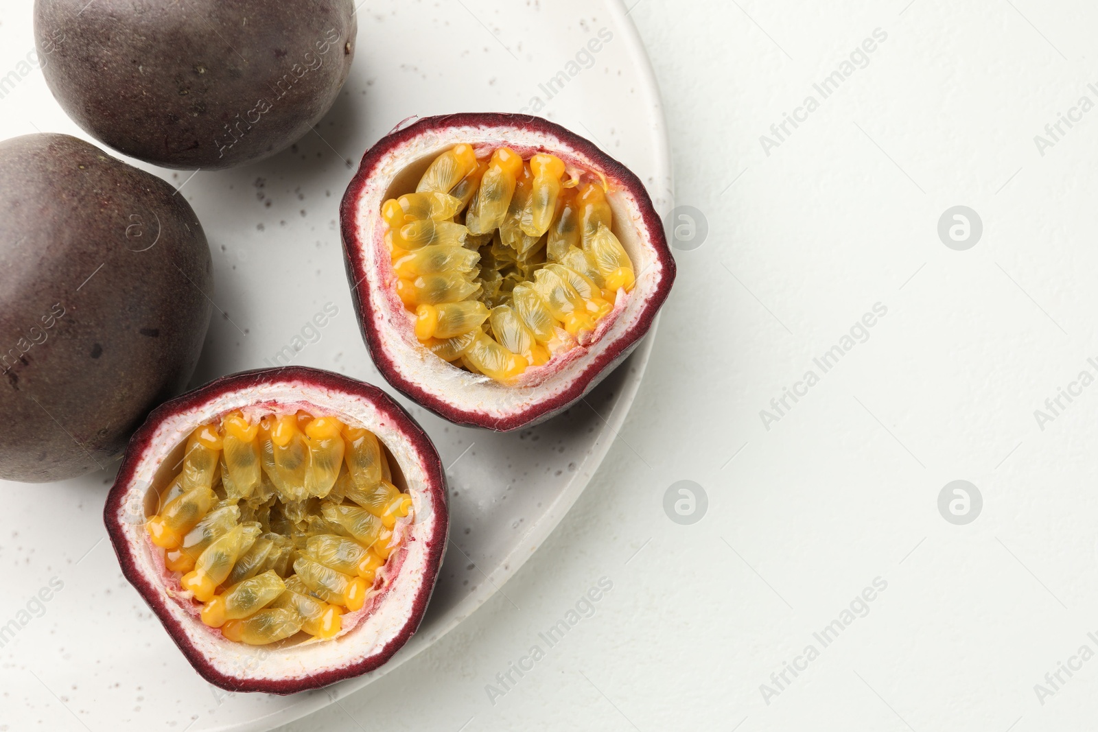 Fresh passion fruits on white table. Space for text Photo of Fresh passion fruits on white table. Space for text