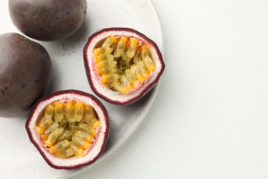 Photo of Fresh passion fruits on white table. Space for text
