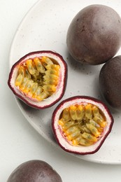 Photo of Fresh passion fruits on white table, above view