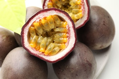 Photo of Fresh passion fruits on white table, closeup