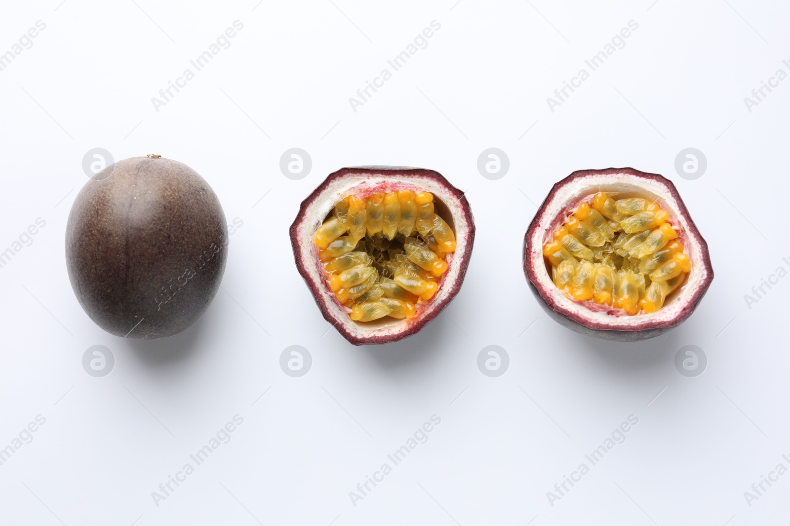 Fresh passion fruits on white background, top view. Whole and cut Photo of Fresh passion fruits on white background, top view. Whole and cut